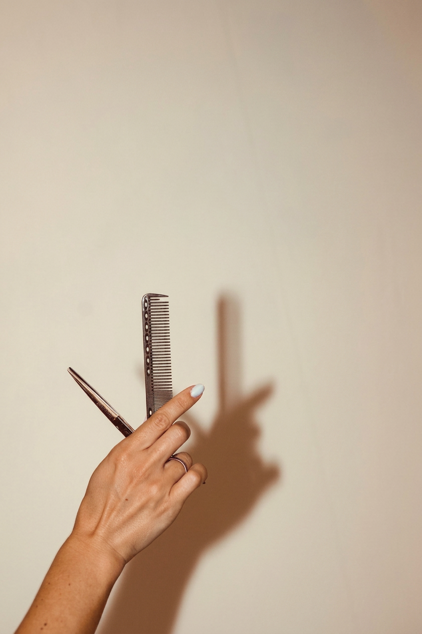 Stylist holding shears and comb